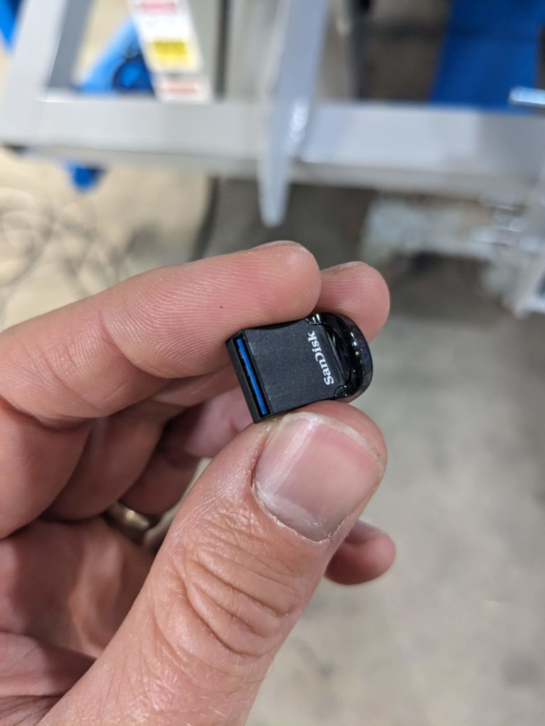 Replacement USB drive fully seated in the touchscreen computer.